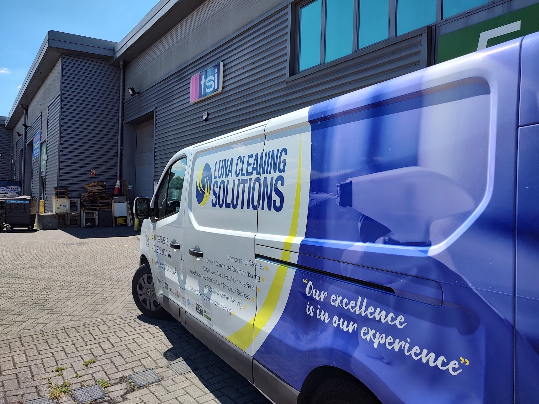 A Luna Cleaning Solutions branded van parked outside a period building
